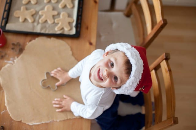 Adorable little boy, preparing cookies for christmas